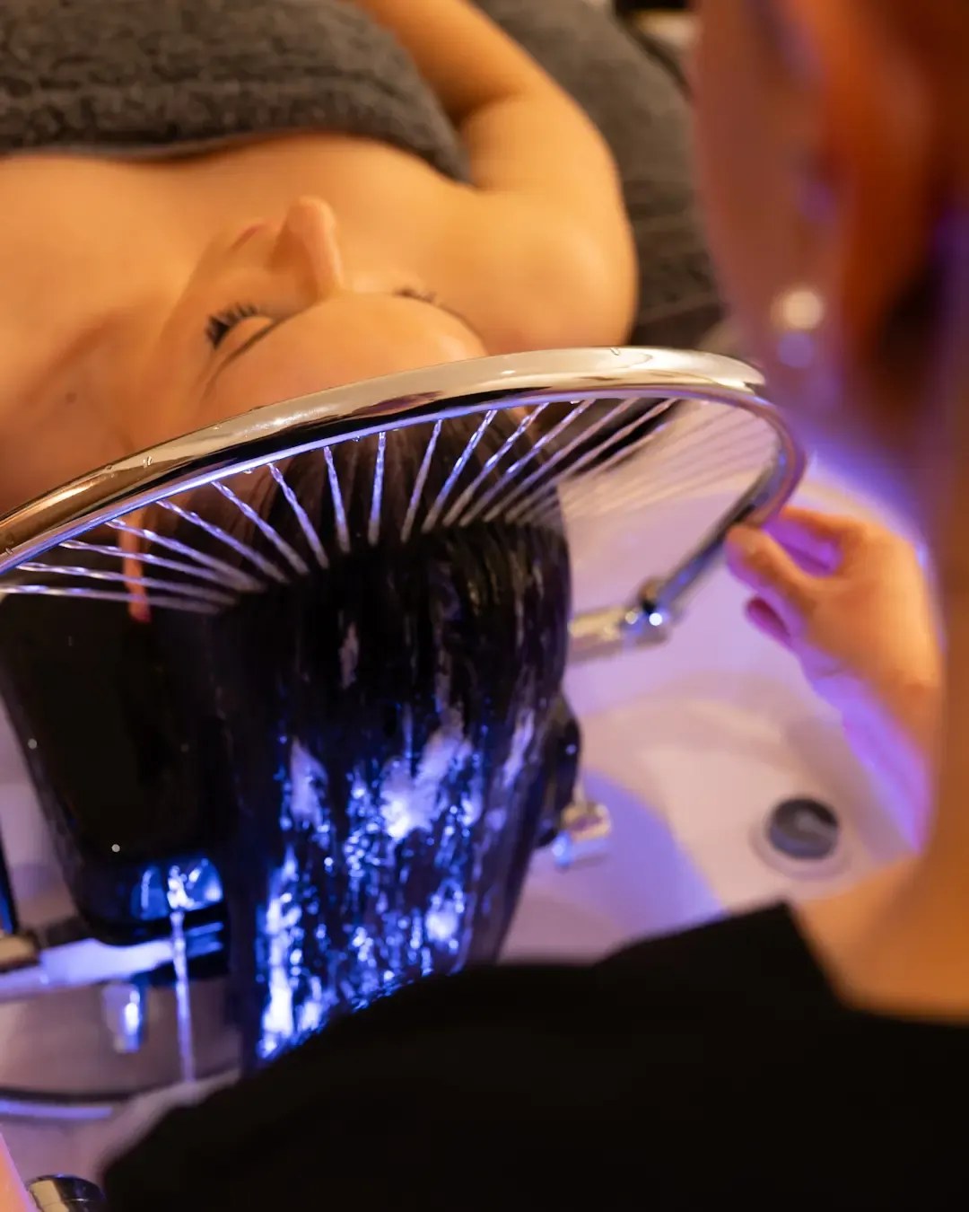 A person receives laser treatment on their face in a beauty salon.